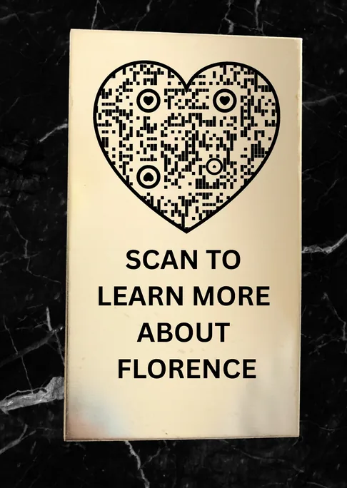 Black memorial plaque with a heart-shaped QR code reading Scan to learn more about Florence